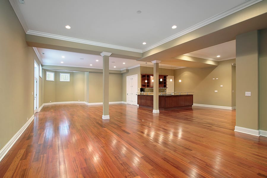 A pristine, empty living room featuring hardwood floors, showcasing a spacious and inviting atmosphere.