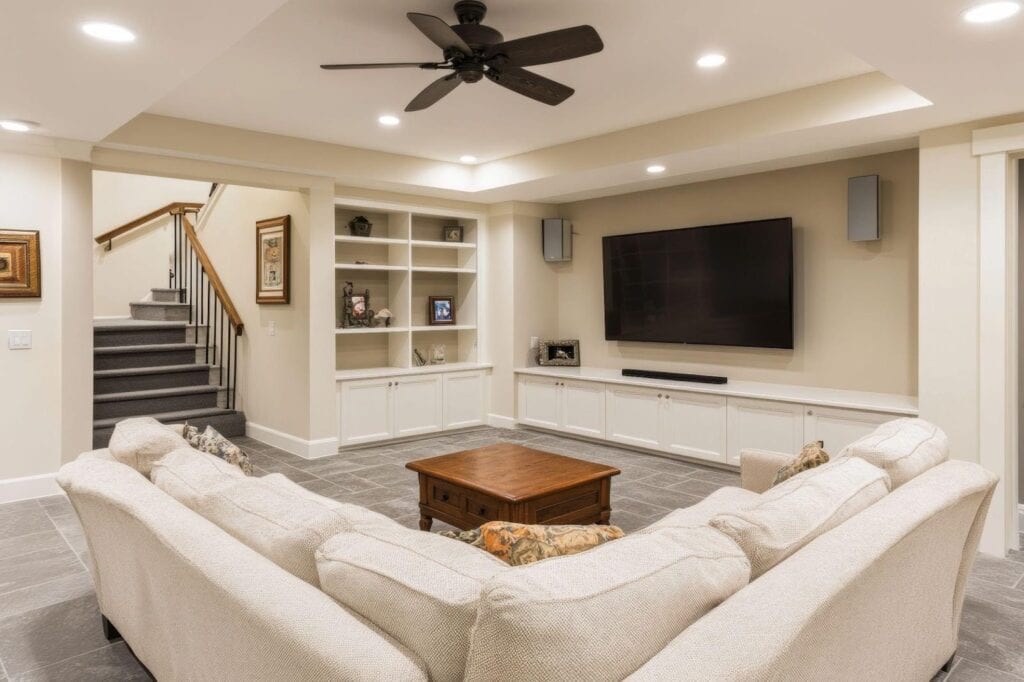 A bright living room with a ceiling fan and a stylish couch inviting comfort and leisure